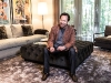 Barry Avrich in the living room of his Toronto home, wearing a suede jacket by Brunello Cucinelli, a Jil Sander cardigan, a John Varvatos T-shirt and denim from AG Jeans, all courtesy of Harry Rosen