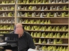 A wall of shoe moulds set the backdrop for a soulful artisan hard at work.