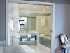 One of the three spacious bathrooms in the suite containing frosted glass doors
