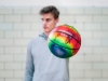 Lauri Markkanen holding the #DontChoke hand-painted basketball with one hand.