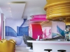 Pink, blue and gold line the walls and plastic fixtures of this highly stylized bar at the Nhow Hotel. Photography by Lukas Roth