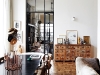 The view through the living area into the TV room/library, flanked by the restored apothecary cabinet, which displays homemade ceramics and local artworks