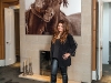 Natasha Koifman stands in front of the fireplace in her master bedroom; the photo  by Roberto Dutesco is from  his collection “The Wild  Horses of Sable Island”