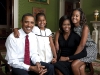 President Barack Obama, First Lady Michelle Obama, and their daughters, Malia and Sasha, sit for a  family portrait in the Green Room of the White House, Sept. 1, 2009.