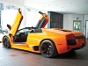 Scissor door extended, this fiery Murciélago makes its presence known.