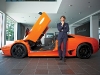 A striking orange Lamborghini Murciélago models with the supercar CEO Stephan Winkelmann.
