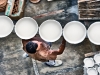 Artisan carrying ceramic plates in Ceramica Artistica Solimene ceramics factory, Vietri Sul Mare, Amalfi Coast. Photo by Robert Leon
