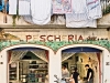 Pescheria (fish shop) and Italian woman in window, Amalfi Village. Photo by Robert Leon