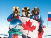 South Pole Quest, 2009. Zahab, Vallely and Arctic explorer Richard Weber huddle together after completing their 33-day expedition from Hercules Inlet, Antarctica to the Geographic South Pole.