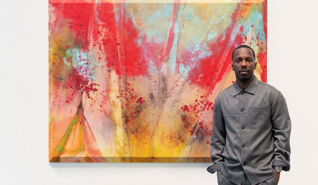Rich Paul standing in front of a painting by Sam Gilliam, Cielo